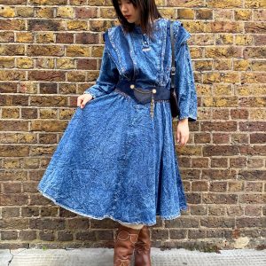 model wearing early 1980s crinkled denim dress styled with boots