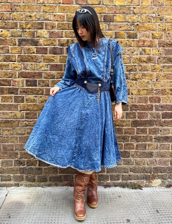 model wearing early 1980s crinkled denim dress styled with boots