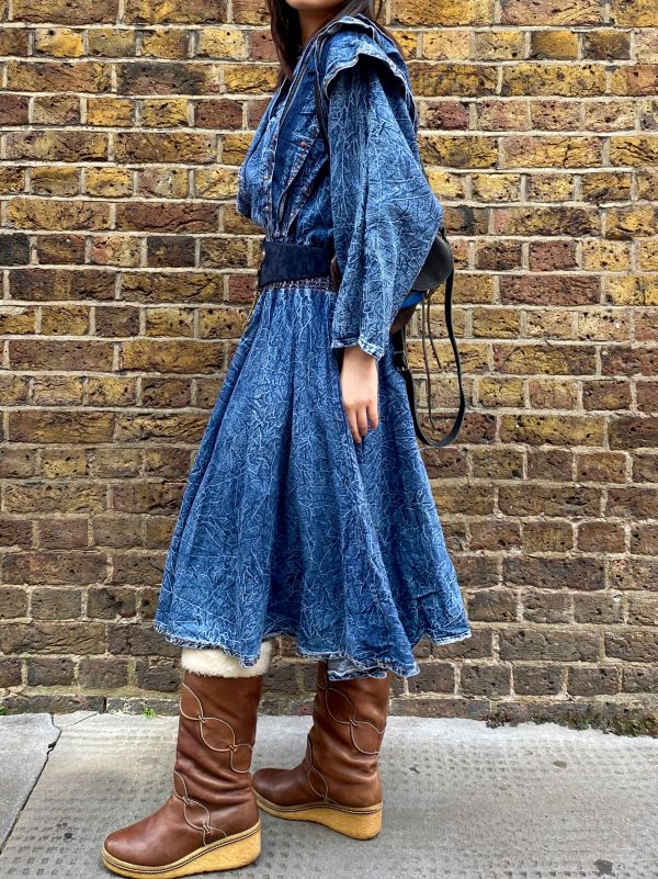 model wearing early 1980s crinkled denim dress styled with boots