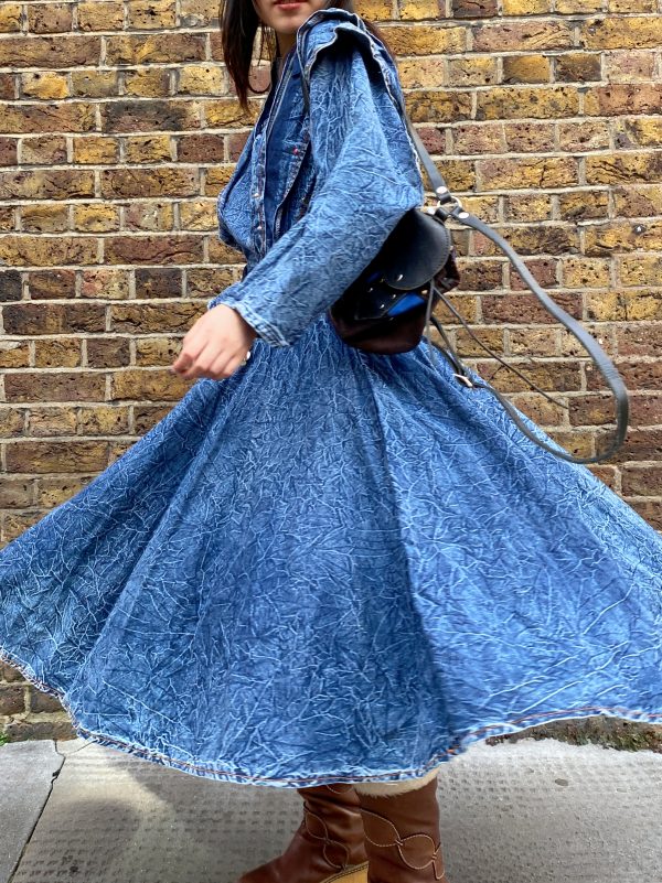 model wearing early 1980s crinkled denim dress styled with boots