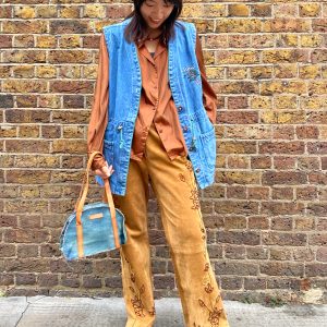 model wearing 1990s embroidered suede trousers with sequin florals and relaxed fit