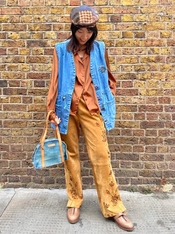 model wearing 1990s embroidered suede trousers with sequin florals and relaxed fit