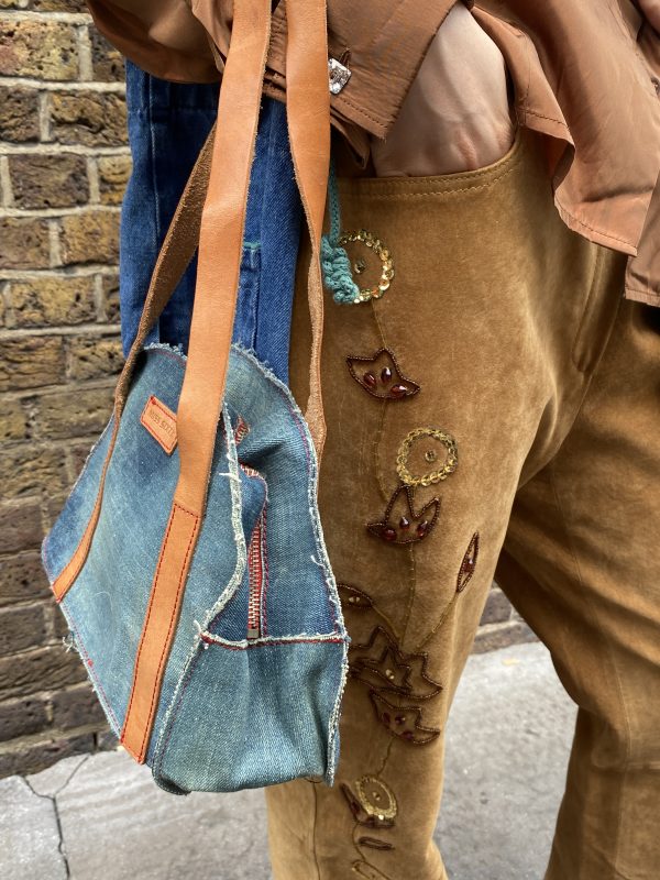 model wearing 1990s embroidered suede trousers with sequin florals and relaxed fit