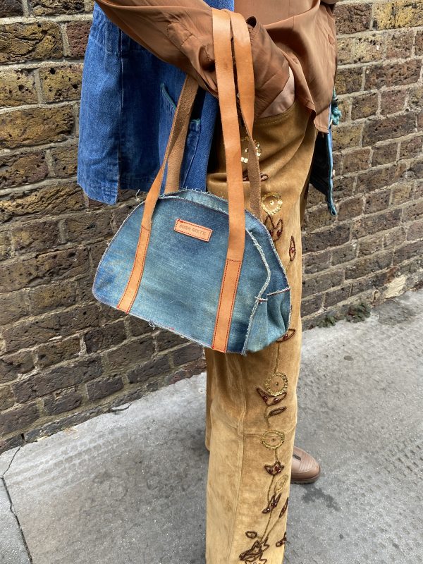 model wearing 1990s embroidered suede trousers with sequin florals and relaxed fit