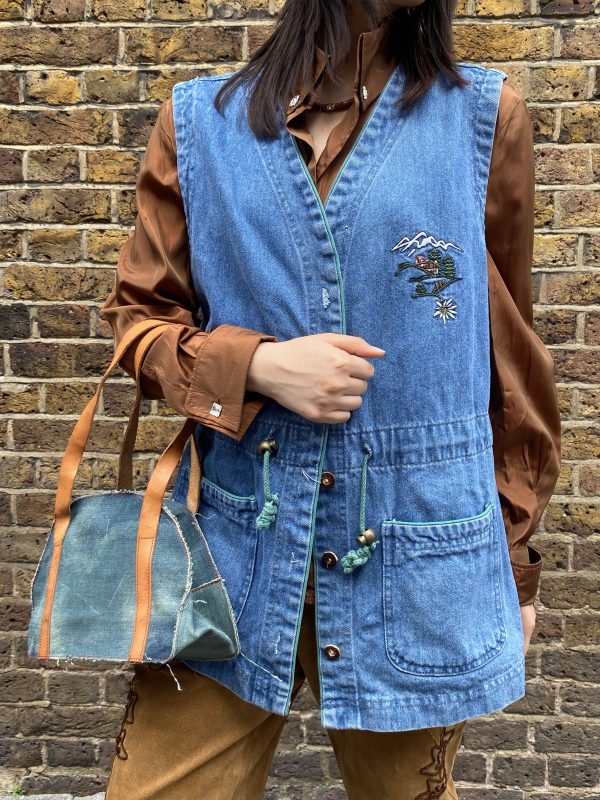 1970s embroidered denim waistcoat with Alpine mountain scene and green piped pockets