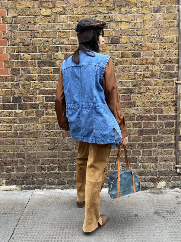 Back of vintage denim waistcoat with detailed mountain embroidery and drawstring waist