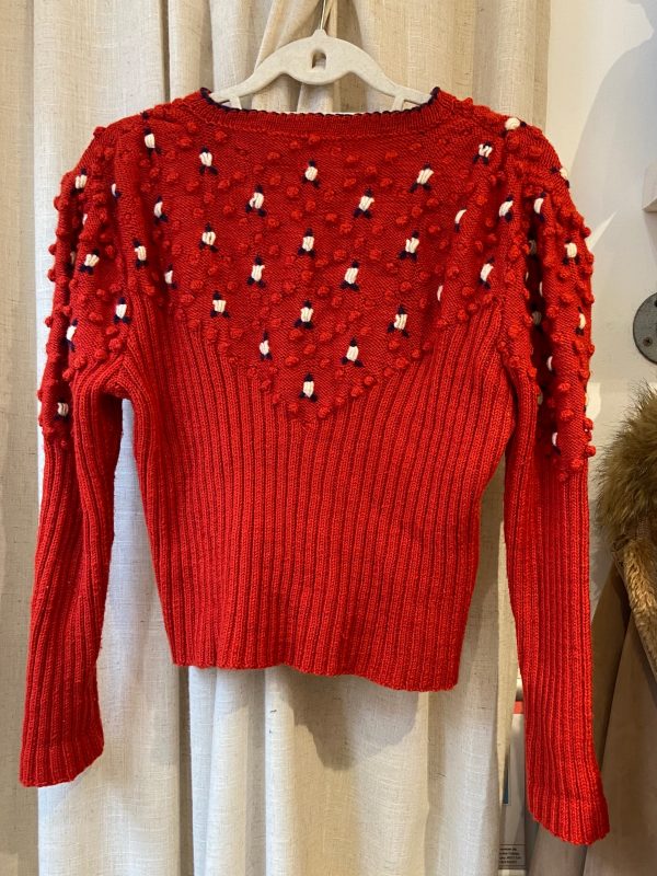 Back view of 1940s hand-knitted red wool cardigan with bobble texture