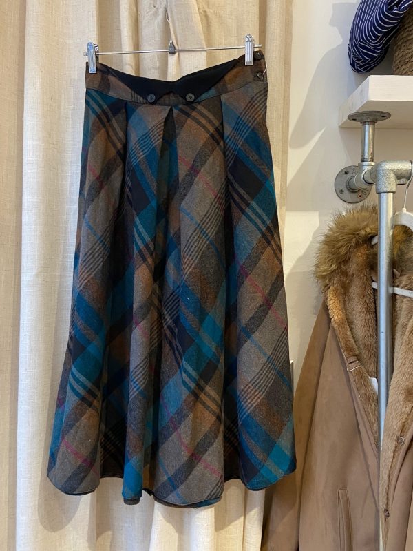 1960s plaid A-line skirt in blue and brown, shown full length with clean tailored silhouette.