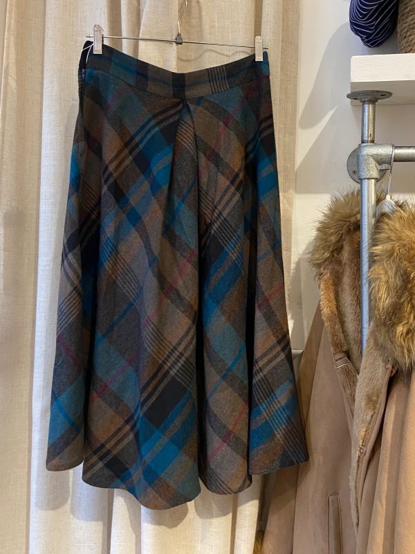 1960s plaid A-line skirt in blue and brown, shown full length with clean tailored silhouette.