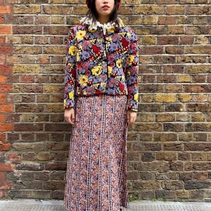 Front view of 1980s quilted floral jacket with bold red and yellow print