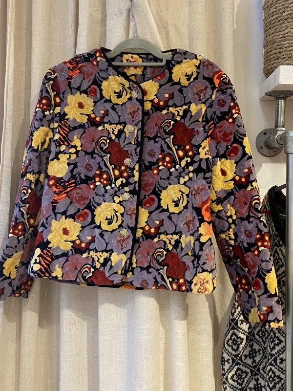 Front view of 1980s quilted floral jacket with bold red and yellow print