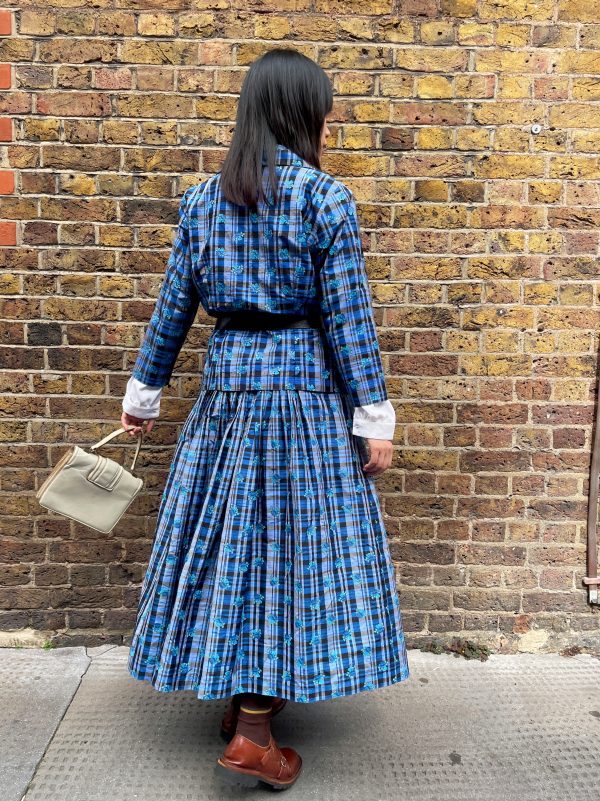 Model wearing early 1980s silk check skirt with matching top, styled with a black belt and white cuffs.