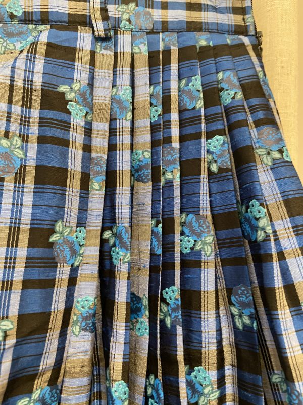 Detail of blue and brown plaid pattern with subtle rose motif on early 1980s silk check skirt.