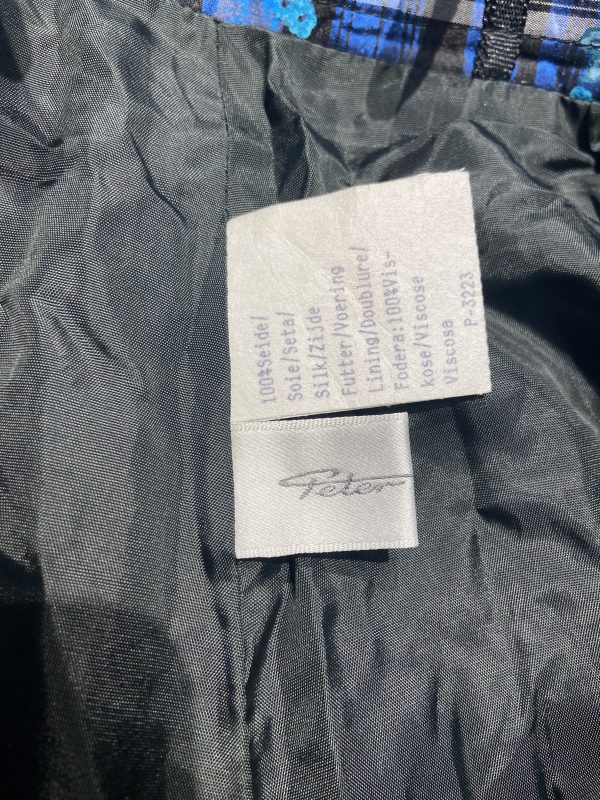 Additional internal label from early 1980s silk check skirt, confirming material and care instructions.