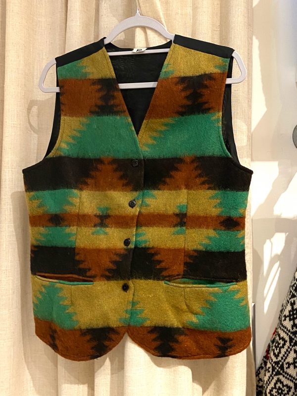 Front view of 1990s wool waistcoat laid flat showing geometric pattern