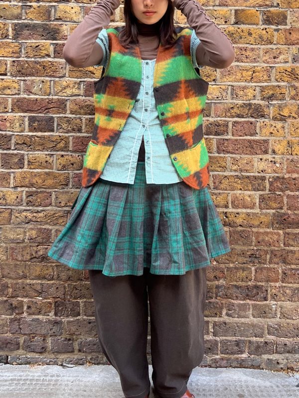 Front view of 1990s wool waistcoat laid flat showing geometric pattern