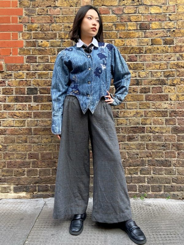 Model wearing 1980s Marciano denim jacket with asymmetrical hem
