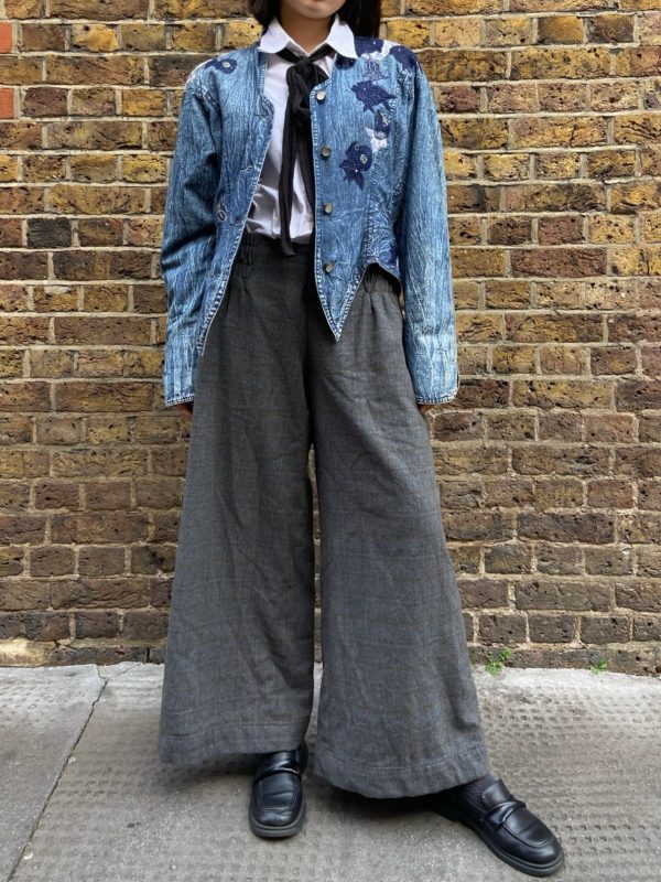 Model wearing 1980s Marciano denim jacket with asymmetrical hem