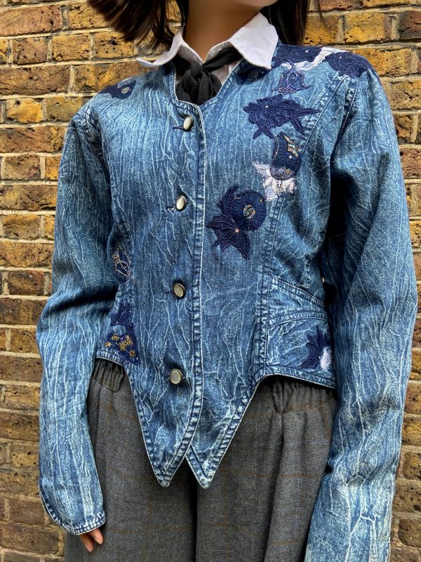 Front view of 1980s Marciano denim jacket with floral embroidery