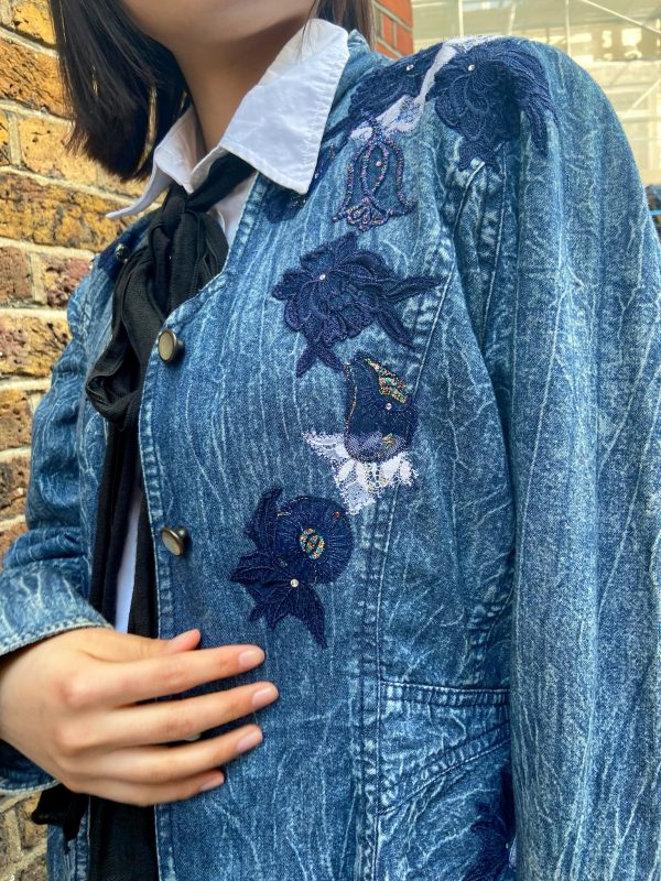 Model wearing 1980s Marciano denim jacket with asymmetrical hem