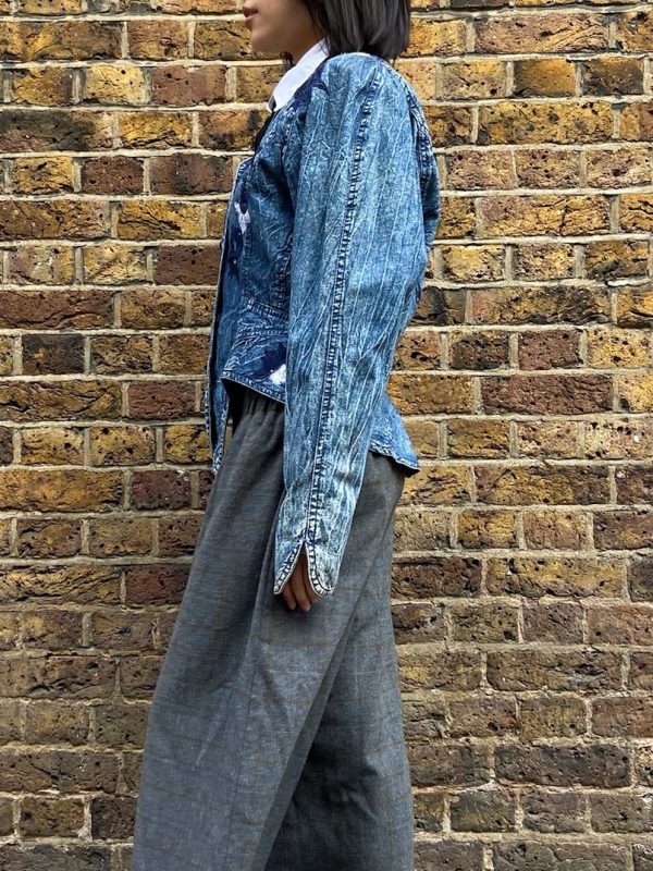 Model wearing 1980s Marciano denim jacket with asymmetrical hem