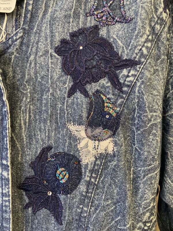 Close-up of floral embroidery on vintage Marciano denim jacket