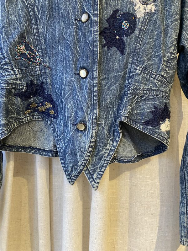 Close-up of floral embroidery on vintage Marciano denim jacket