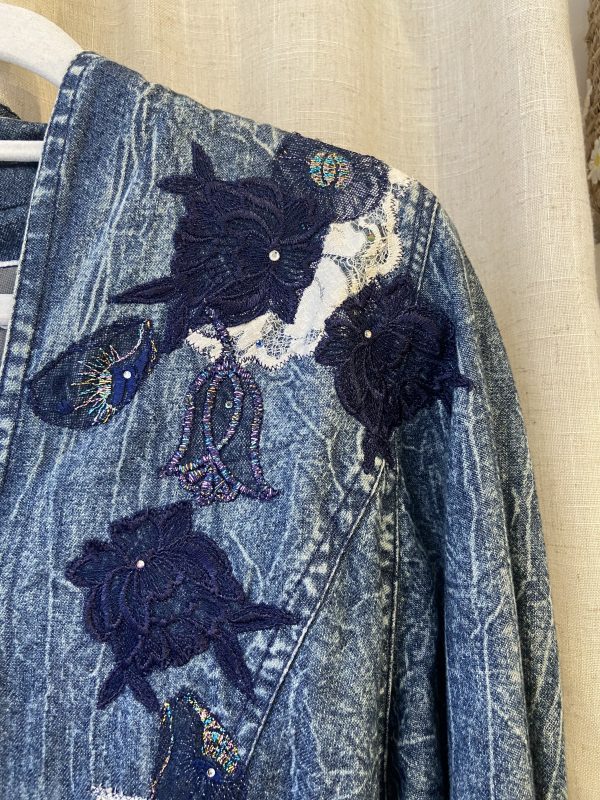 Close-up of floral embroidery on vintage Marciano denim jacket