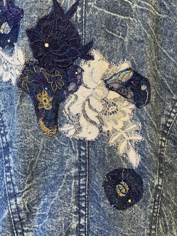 Close-up of floral embroidery on vintage Marciano denim jacket