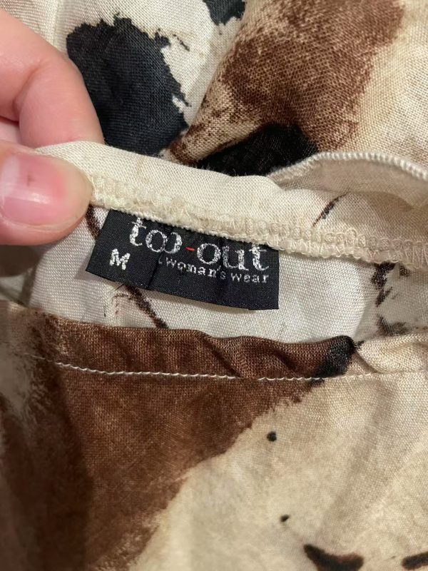 Close-up of top-out women’s wear label on early 2000s outfit