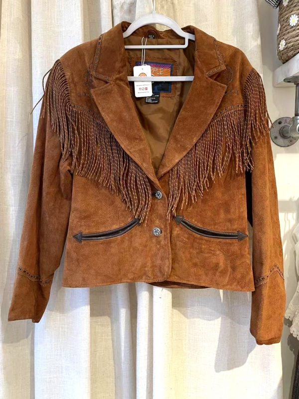 Front view of vintage tan suede jacket with long fringe and snap closure