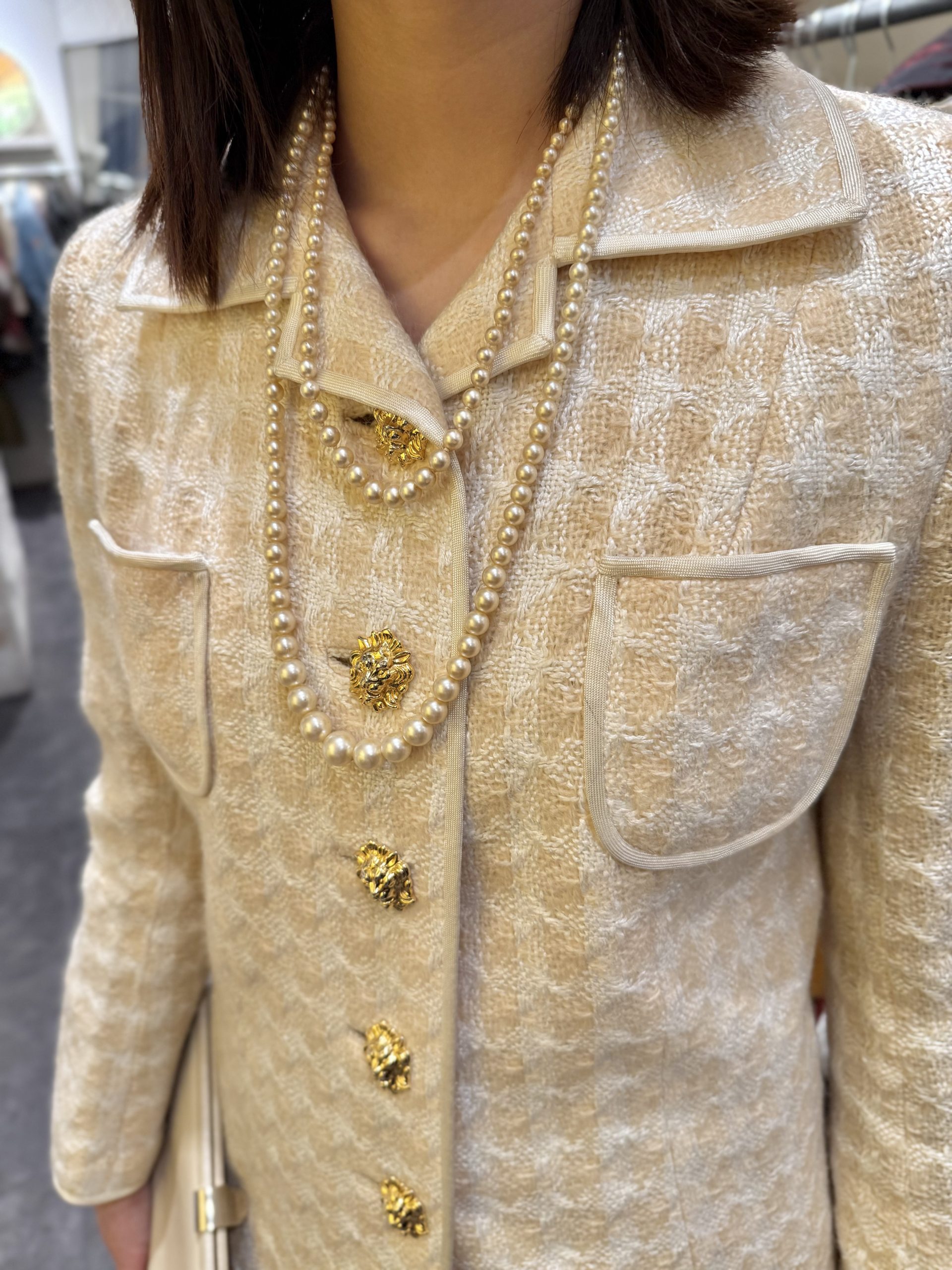 Late 1960s Textured Tweed Skirt Suit 4 - Gong Nong Bing Vintage Close-up of buttons on 1960s tweed skirt suit with pearl necklace styling